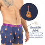 A man wears Guitar Underwear in navy blue with a musical print; a close-up shows tiny perforations and a moisture-wicking, breathable inner lining—ideal for music lovers wanting all-day comfort.