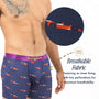 A person models Racing Car Underwear in navy blue with a red car print; a circular inset reveals the perforated, breathable lining. Highlighted text notes these moisture-wicking boxers are ideal for motorsport enthusiasts.