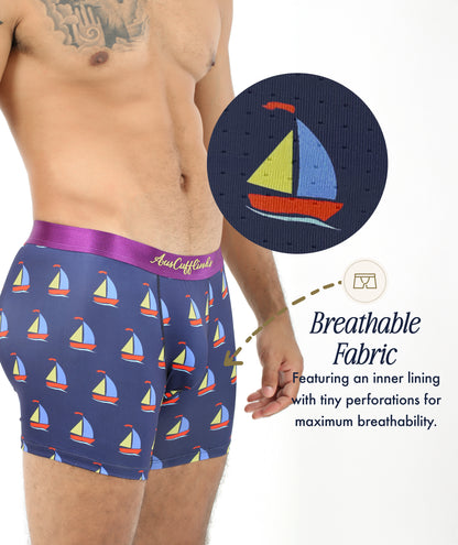 A man wears Sail Boat Underwear featuring a sailboat print; an inset displays a close-up of the breathable, perforated fabric that highlights the maritime-inspired design.