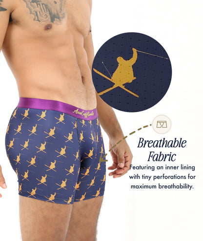 Man wearing navy Ski Underwear with a skier pattern, showcasing the breathable inner lining’s small perforations. Text reads: "Breathable fabric"—ideal ski underwear for winter sports fans.