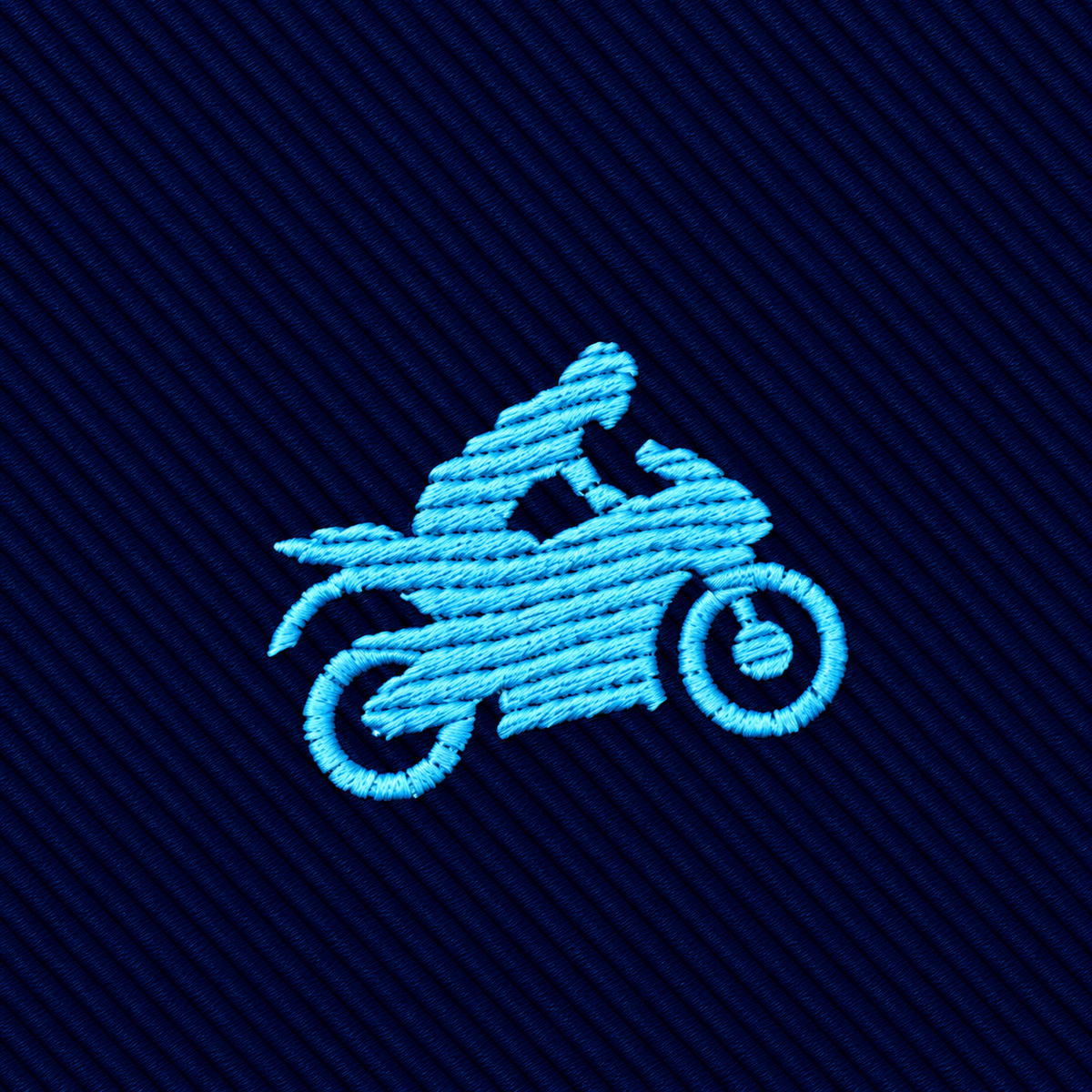 A light blue embroidered motorcycle icon on a dark blue diagonally ribbed microfiber Motorbike Skinny Tie.