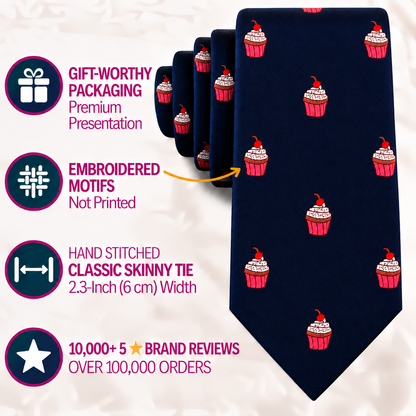 Dark blue Muffin Skinny Tie featuring a repeating pattern of embroidered cherry-topped cupcakes, with callouts highlighting its packaging, stitching, width, and brand reviews.
