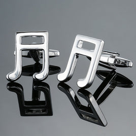 Music Note Cufflinks shaped like silver notes, displayed on a reflective surface—perfect men's music accessories and an ideal gift for musicians.