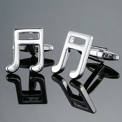 Music Note Cufflinks shaped like silver notes, displayed on a reflective surface—perfect men's music accessories and an ideal gift for musicians.