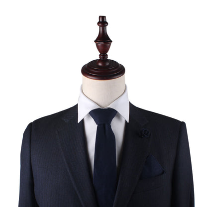 A mannequin elegantly dons a dark suit, white shirt, and the Navy Cotton Business Tie & Pocket Square Set, featuring a flower pin on the lapel to create lasting impressions.