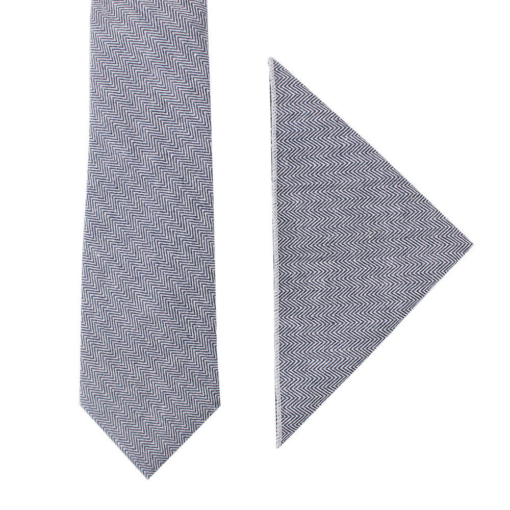 The Navy Herringbone Cotton Business Tie & Pocket Square Set is elegantly displayed on a crisp white background.