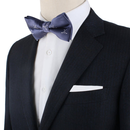 A mannequin dressed in a dark suit, white shirt, and the Ice Hockey Cross Bow Tie brings a sporty flair, complemented by a crisp white pocket square.