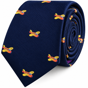 Orange Aircraft Skinny Tie in navy blue rolled into a coil, featuring a repeating pattern of small orange and yellow airplane illustrations.