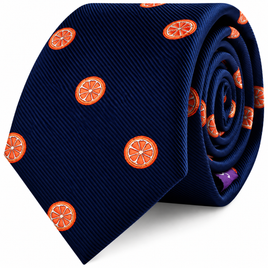 Rolled navy blue Orange Skinny Tie featuring a vibrant orange citrus slice pattern.