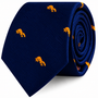 An Orange Fox Skinny Tie in navy blue with a diagonal ribbed texture and an orange fox pattern, rolled into a coil.