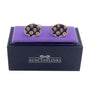 The Ladybug Orange Navy Cufflinks feature a silver design with orange and black polka dots, elegantly displayed on a purple velvet cushion atop a navy box labeled "AusCufflinks," ideal for the modern gentleman.