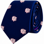 A rolled-up navy blue Piggy Bank Skinny Tie featuring a repeating pattern of small pink piggy banks.