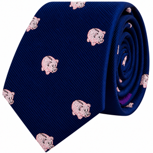 A rolled-up navy blue Piggy Bank Skinny Tie featuring a repeating pattern of small pink piggy banks.