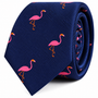 A navy blue Flamingo Skinny Tie featuring a repeating pattern of pink flamingos as a statement accessory.