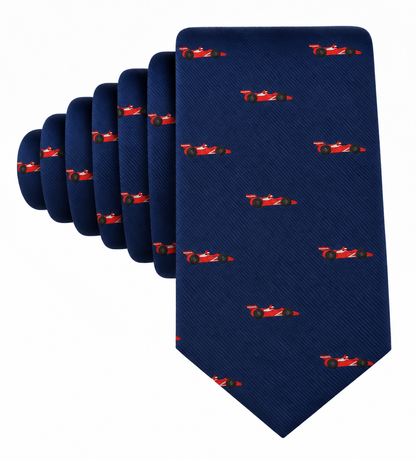 Introducing the Racing Car Skinny Tie in navy blue, showcasing a repeating pattern of small red race cars arranged evenly across the fabric—a stylish motorsports accessory perfect for enthusiasts.