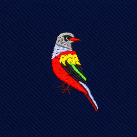 Red Parrot Skinny Tie featuring an embroidered parrot in red, yellow, green, and white on dark blue ribbed fabric.