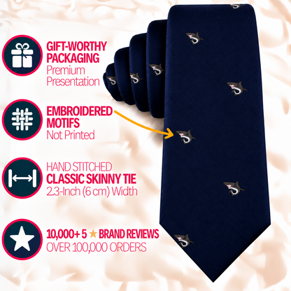 A dark blue Great White Shark Skinny Tie with small embroidered motifs, presented with text highlighting its premium packaging, 2.3-inch width, and brand reviews.