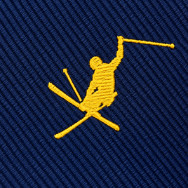 The Ski Tie features a yellow embroidered skier with two poles set against a blue textured fabric background—making it an ideal ski gift or a stylish winter tie for any enthusiast.