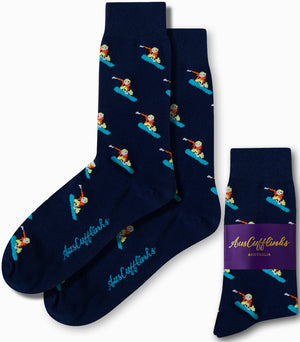 Navy blue socks showcasing a repeating pattern of snowboarders, with the brand name "AusCufflinks Australia" introducing a cool alpine style on the packaging.
