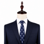 A mannequin showcases the Soccer Skinny Tie—a navy soccer ball print tie—paired with a pinstripe suit and white shirt, making it the perfect gift for any stylish soccer fan.