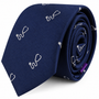 The Stethoscope Skinny Tie is a navy blue necktie featuring a subtle white stethoscope pattern, rolled with the pointed end facing forward—an ideal accessory for medical professionals seeking a refined touch.