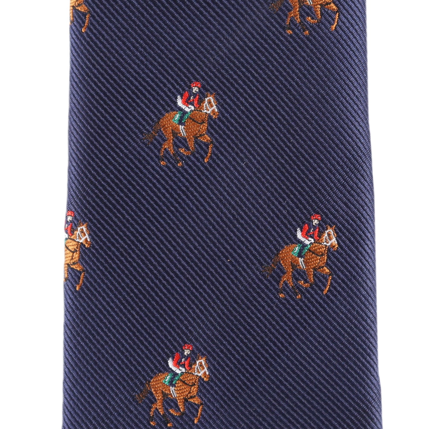 Close-up of the Thoroughbred Racing Horse Skinny Tie in navy blue, featuring a pattern of evenly spaced embroidered jockeys on horses.