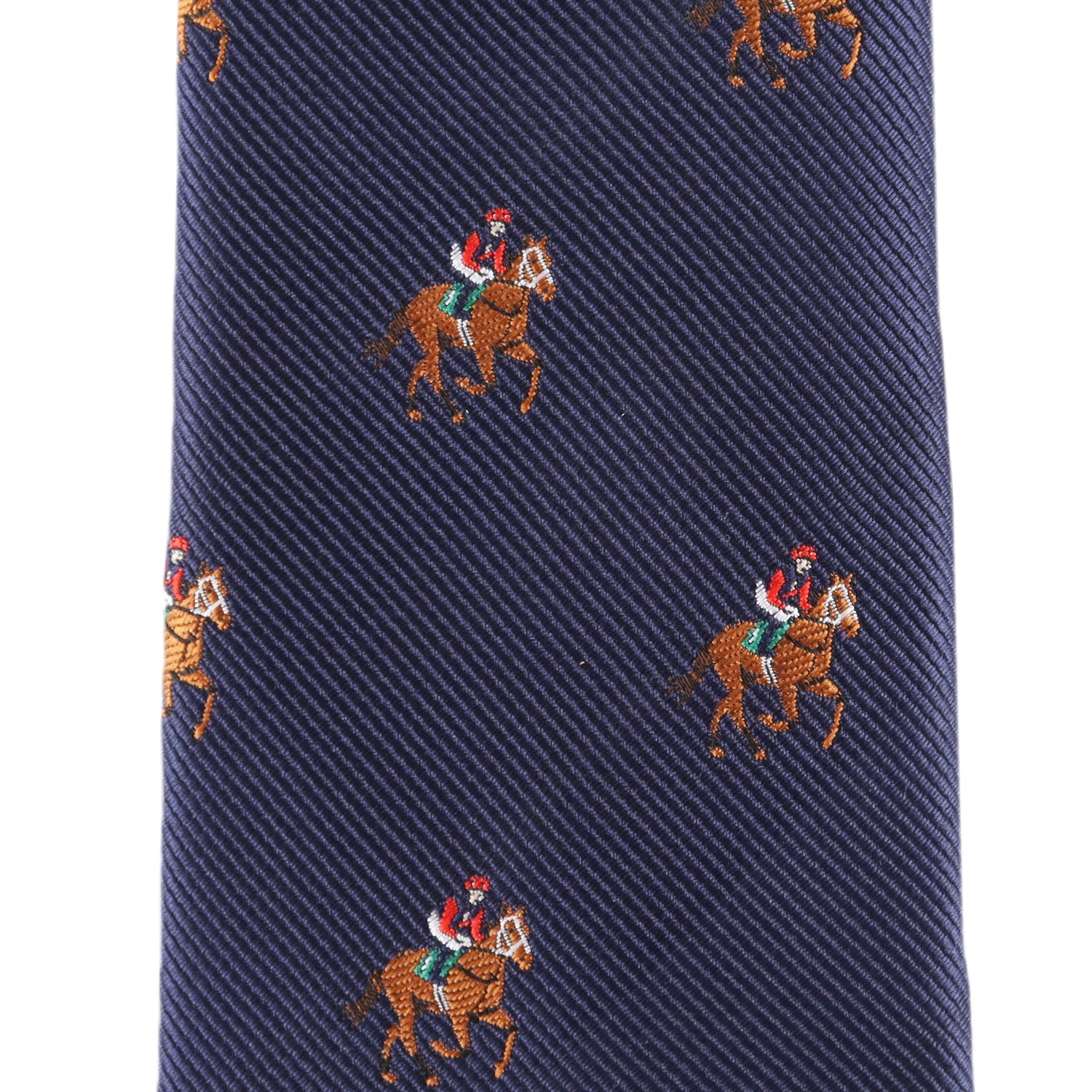 Close-up of the Thoroughbred Racing Horse Skinny Tie in navy blue, featuring a pattern of evenly spaced embroidered jockeys on horses.