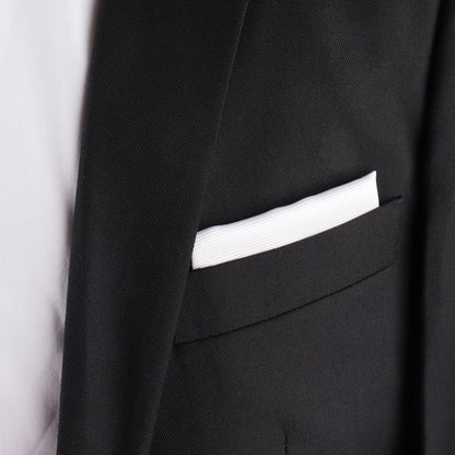 Close-up of a black suit jacket radiating elegance, featuring a White Silk Handkerchief neatly placed in the breast pocket.