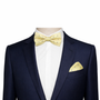 A mannequin dressed in a pinstripe suit and white shirt, accented by a Yellow Navy Polka Dot Bow Tie for men with a matching pocket square.
