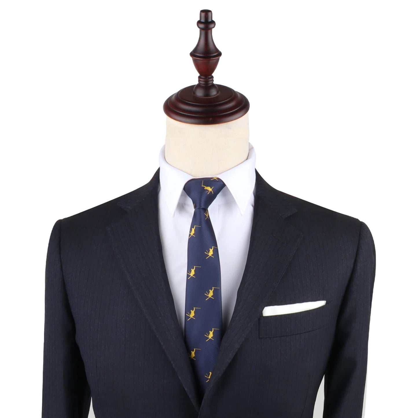 A tailored dark suit with a white shirt, complemented by a Ski Tie and a pristine white pocket square, displayed on a mannequin.