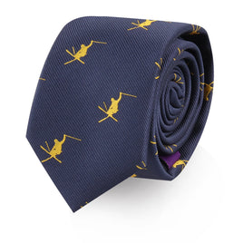A navy blue Ski Tie, featuring a pattern of yellow embroidered skiers, rolled up on a white background.