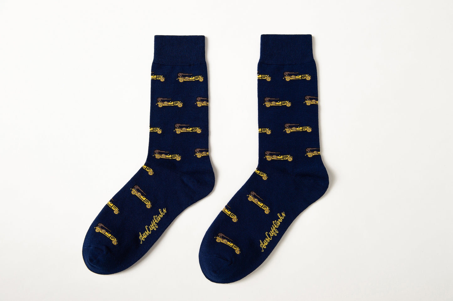 Fun novelty socks for men featuring gold vintage car design on navy background
