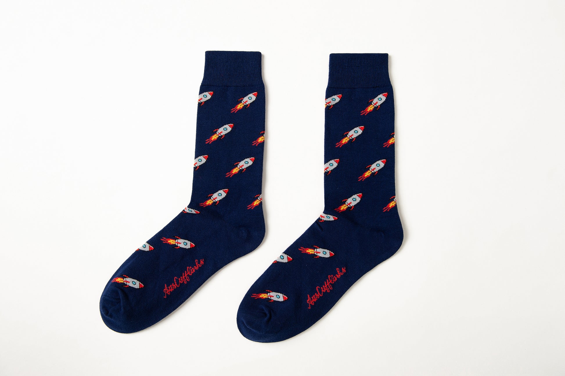 Fun novelty space socks for men featuring rocket ship design on navy background
