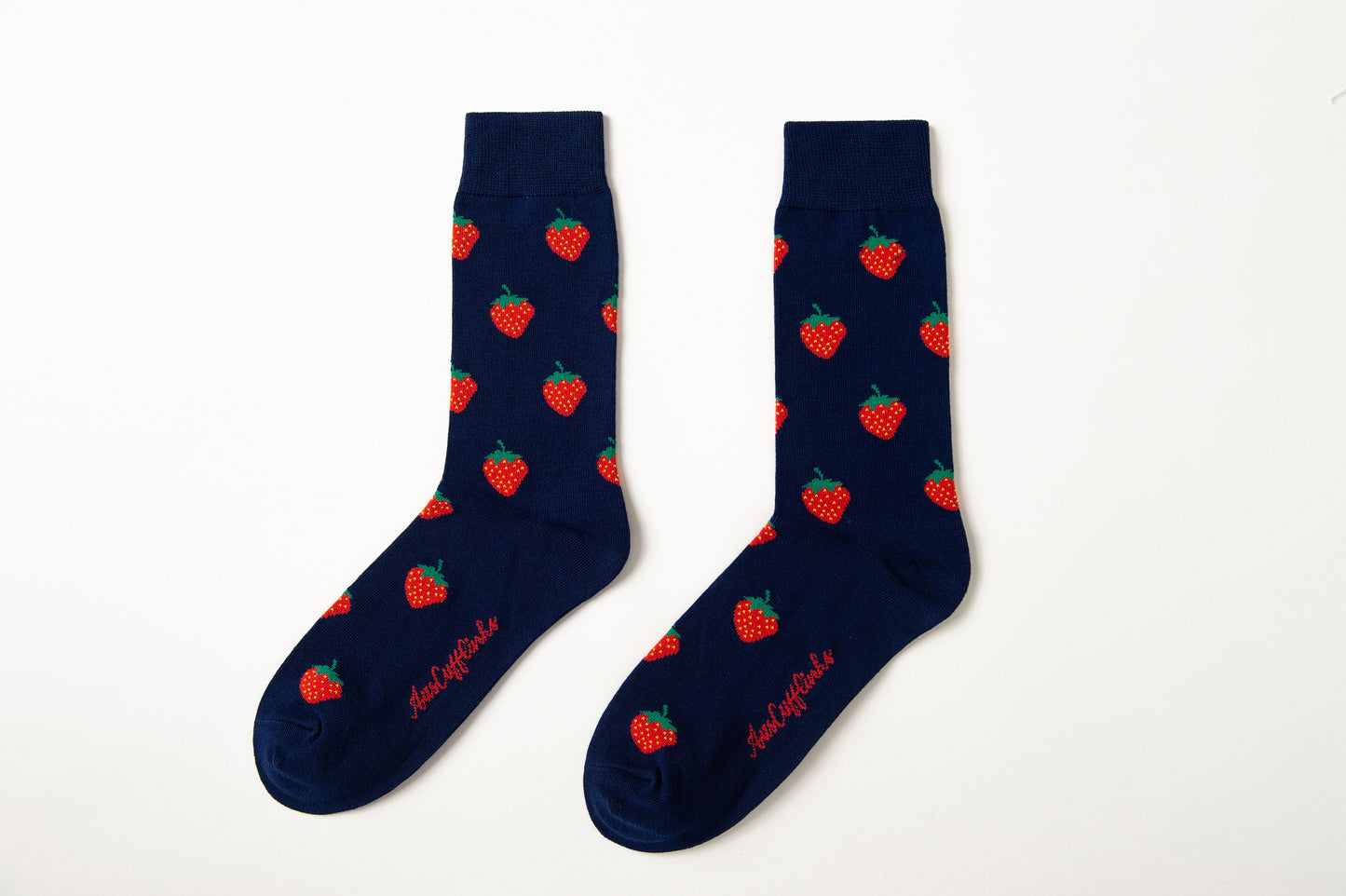 Fun novelty fruit socks for men featuring red strawberry design on navy background