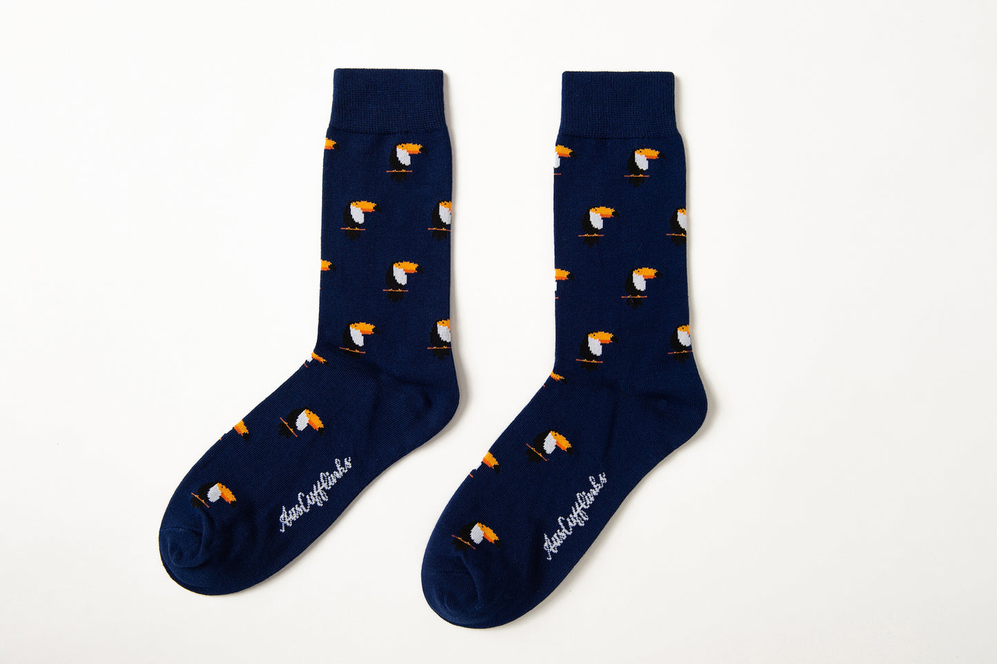 Fun novelty tropical bird socks for men featuring vibrant toucan design on navy background