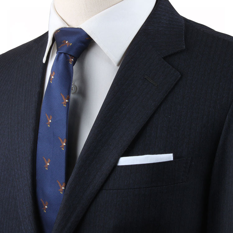 A mannequin wearing a blue suit with an Eagle Skinny Tie, exuding power and grace with an eagle motif.