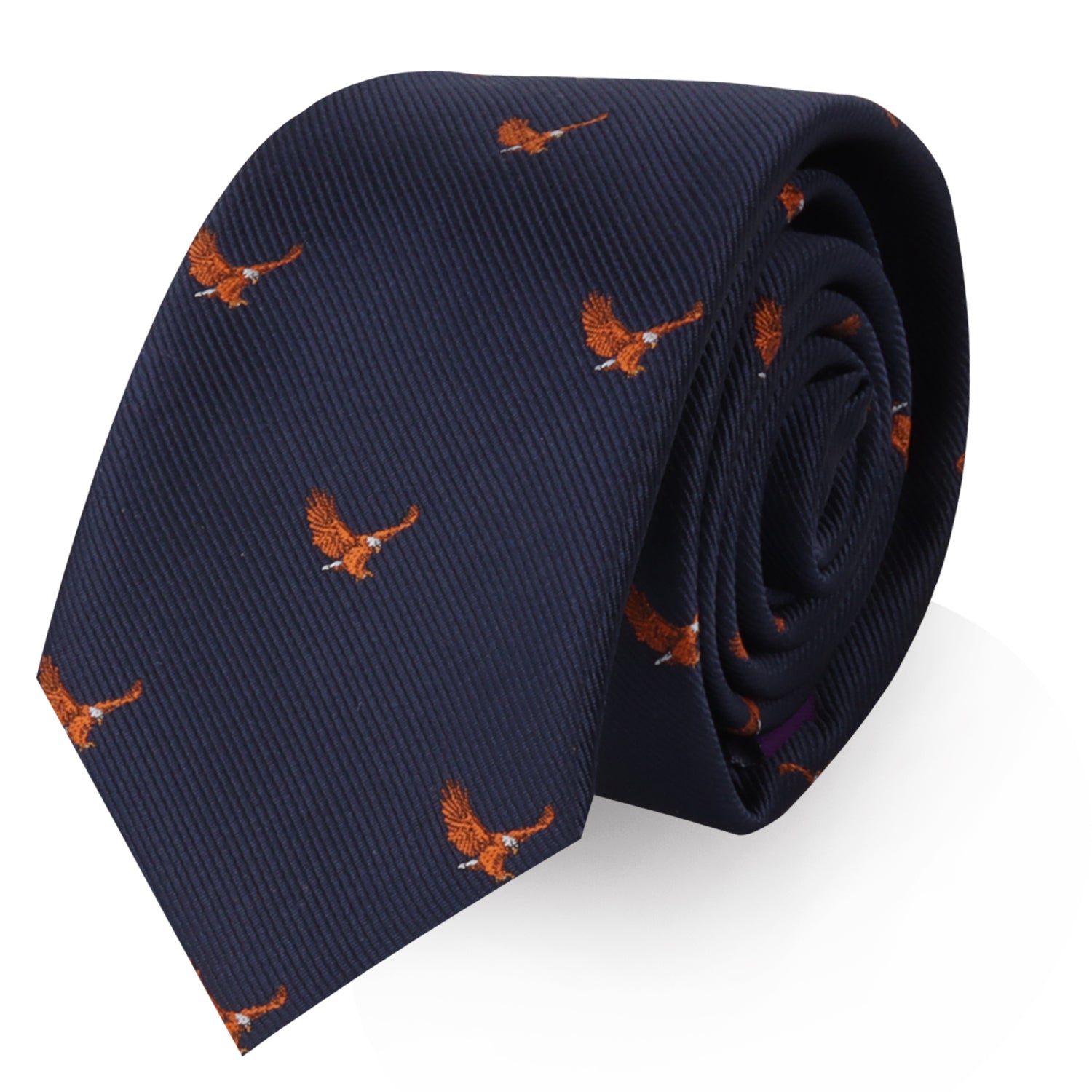 Discover the Flying Eagle Skinny Tie, a rolled-up navy blue accessory adorned with a pattern of small orange bird motifs that brings an element of majestic fashion to any outfit.