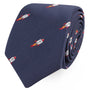 The Rocket Skinny Tie, featuring a pattern of small, embroidered red and white rocket ships on a navy blue background, offers peak elegance and is neatly rolled.