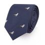 The Seagul Skinny Tie, featuring an embroidered seagull pattern on a navy blue fabric, is the perfect accessory for those who soar coast to coast in style, rolled up neatly.