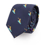 The Snowboarder Skinny Tie is a neatly rolled navy blue tie adorned with small, embroidered yellow and blue pelican motifs, perfect for those who appreciate a dash of style in their attire.