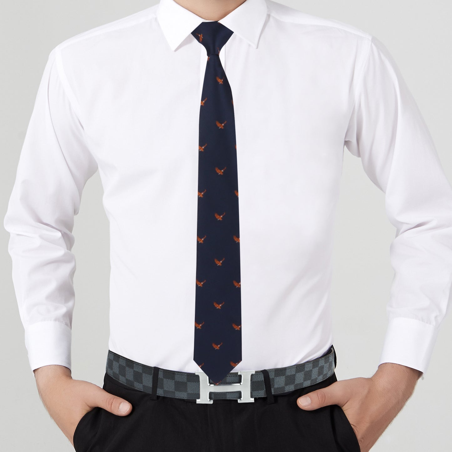 A person dressed in majestic fashion wears a crisp white dress shirt, black dress pants, the Flying Eagle Skinny Tie with red designs, and a checkered belt with a silver buckle.