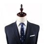 Mannequin dressed in a dark suit, white shirt, and Panda Skinny Tie exudes modern sophistication.