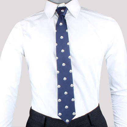 A person wearing a white dress shirt, a Panda Skinny Tie with small white skull patterns that add playful charm, and dark trousers exudes modern sophistication.