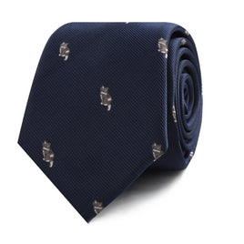 A rolled-up Misty Cat Skinny Tie exuding charm and sophistication with a pattern of small embroidered dogs.