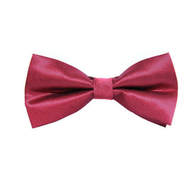 A classic red bow tie on a white background.