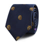 The King Lion Skinny Tie is a rolled-up navy blue accessory beautifully adorned with small yellow and brown lion head motifs, symbolizing leadership and courage.