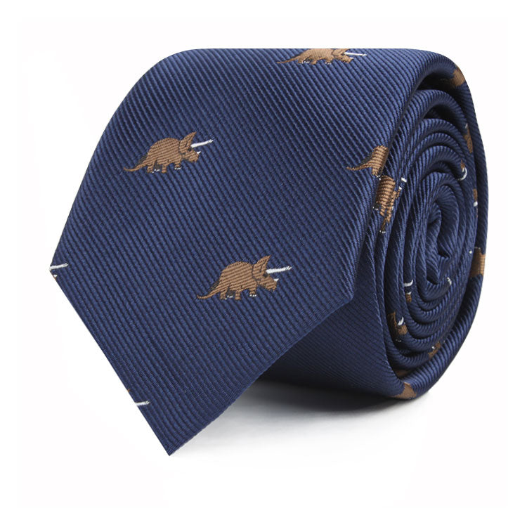 A rolled-up blue Triceratops Skinny Tie featuring a pattern of small, brown triceratops dinosaurs throughout, blending modern elegance with prehistoric charm.