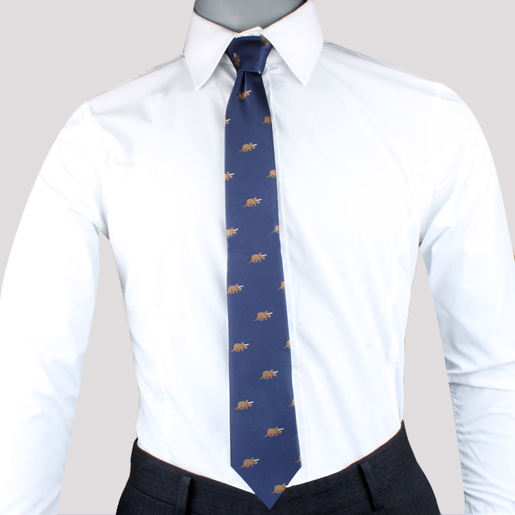 Mannequin dressed in a white dress shirt and a Triceratops Skinny Tie with gold embroidered patterns, exuding modern elegance.