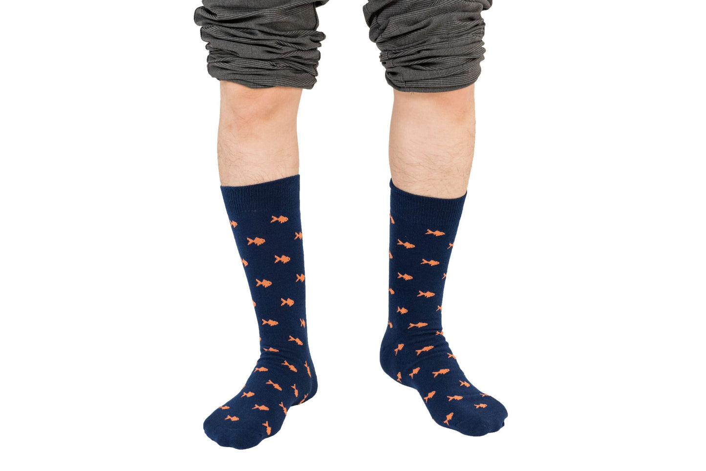 A boy wearing a pair of Gold Fish Socks with orange stars on them.