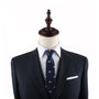 A headless mannequin dressed in a dark suit with a white shirt and a Dumplings Skinny Tie, exuding timeless elegance.